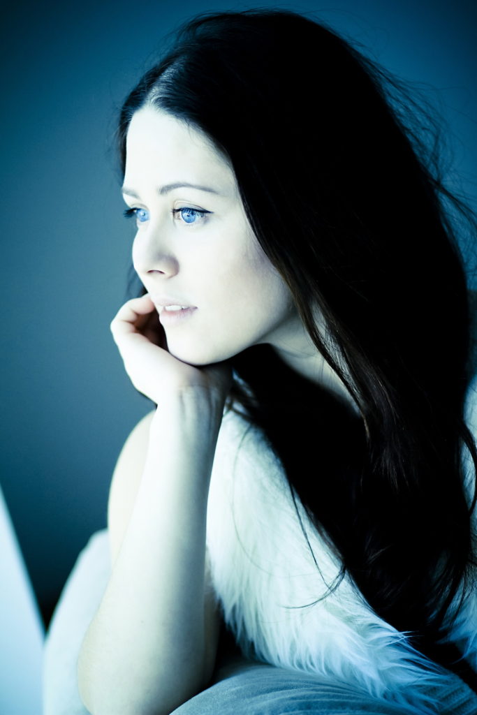 beautiful girl with striking blue eyes looking out of the window_4_resize